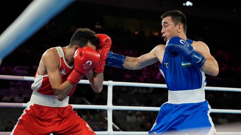 France's Billal Bennama, left, fights Uzbekistan's Hasanboy Dusmatov in their...