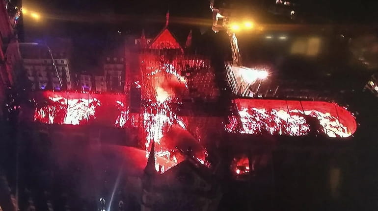 An aerial view of Notre Dame Cathedral engulfed in flames...