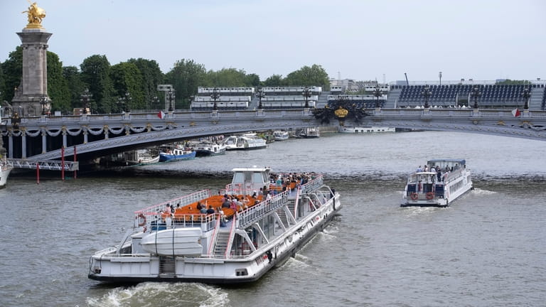 Tourists barges pass under the Alexandre III bridge, Friday, June...