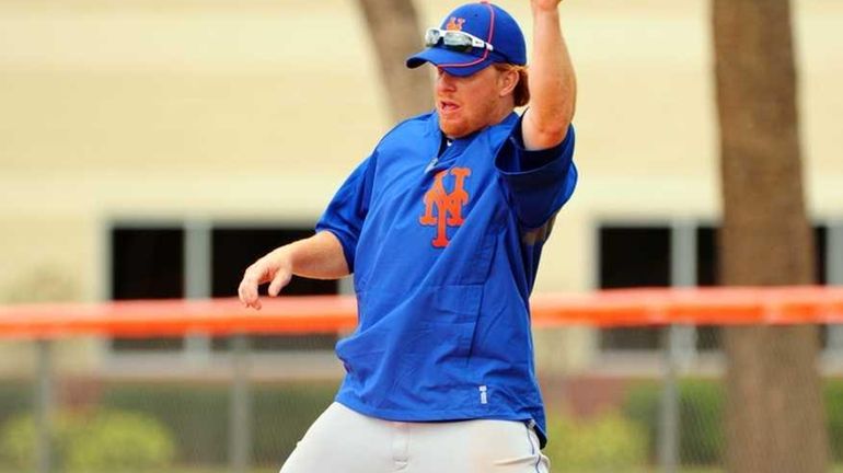 Mets' Justin Turner works out at first base during spring...