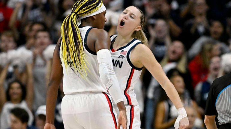 UConn guard Paige Bueckers, right, chest-bumps Aaliyah Edwards during the...