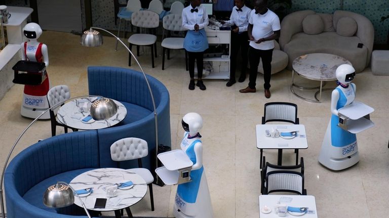 Robotic waiters stand at Robot Cafe in Nairobi, Kenya Thursday,...