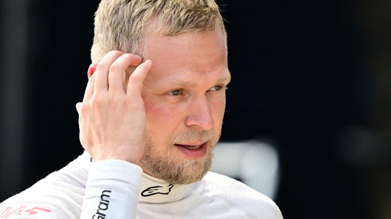 Haas driver Kevin Magnussen of Denmark walks at the Red...