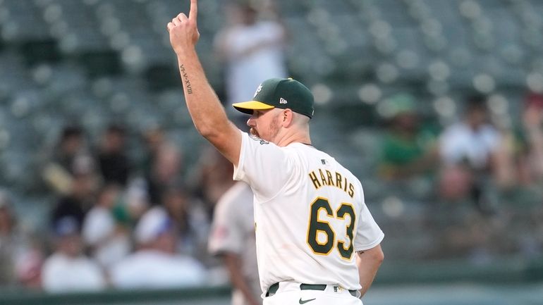 Oakland Athletics pitcher Hogan Harris (63) reacts after Houston Astros'...