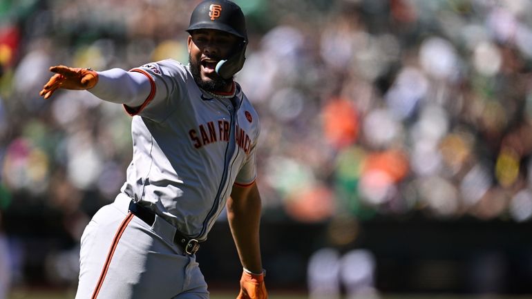 San Francisco Giants' Jerar Encarnacion celebrates after his two-run home...