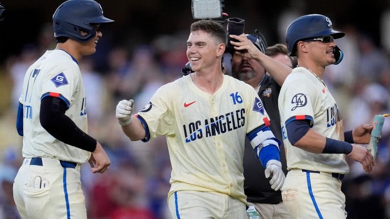 Los Angeles Dodgers' Will Smith, center, celebrates with Shohei Ohtani,...