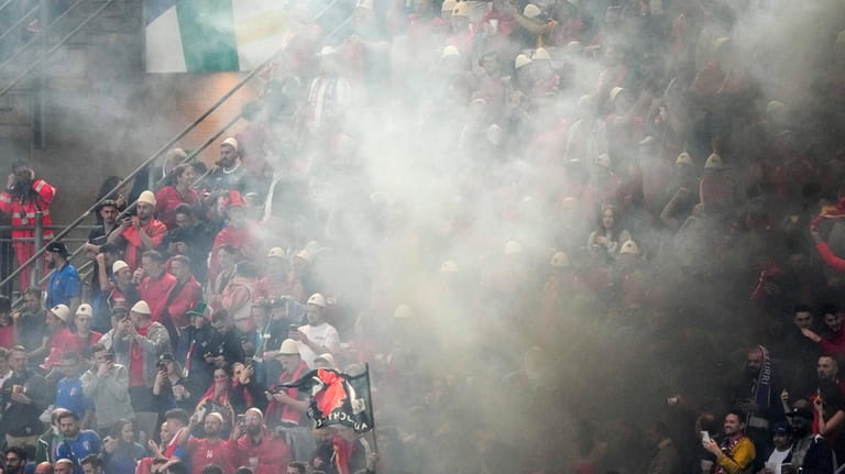 Smoke engulfs Albanian fans after Albania's Nedim Bajrami scored his...
