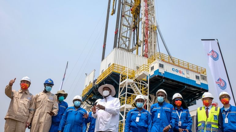 Uganda's President Yoweri Museveni, center, accompanied by workers from China...