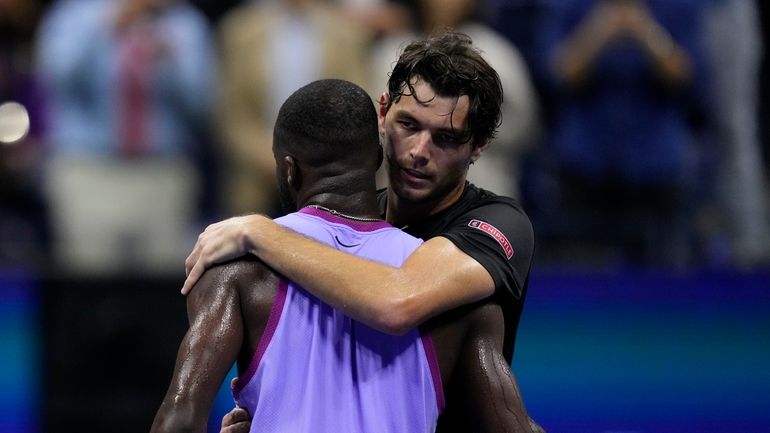 Taylor Fritz, of the United States, hugs Frances Tiafoe, of...