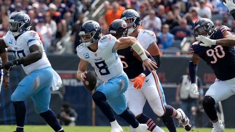 Tennessee Titans quarterback Will Levis scrambles during the first half...