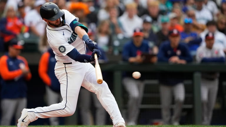 Seattle Mariners' Mitch Haniger hits an RBI single against the...