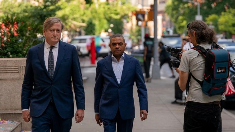 Jose Uribe, center, leaves Manhattan federal court, Friday, June 7,...