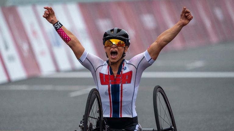 Oksana Masters, of the United States, celebrates after winning at...