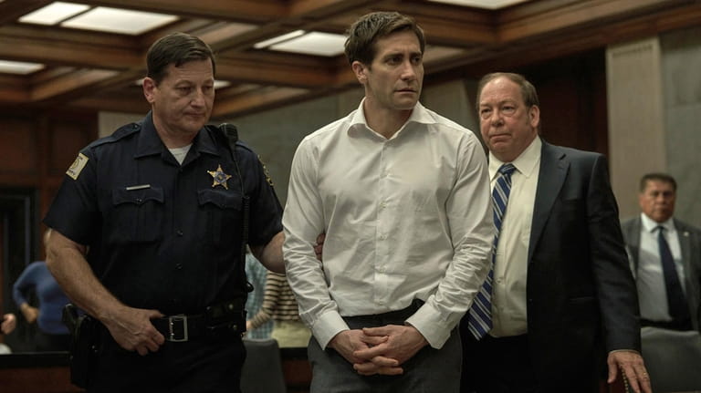 This image released by Apple TV+ shows Jake Gyllenhaal, center,...