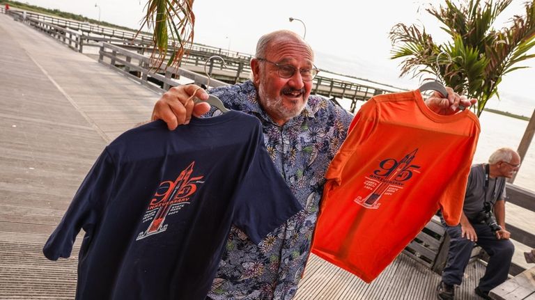 Phil Jimenez holds up T-shirts commemorating the 95th anniversary of...