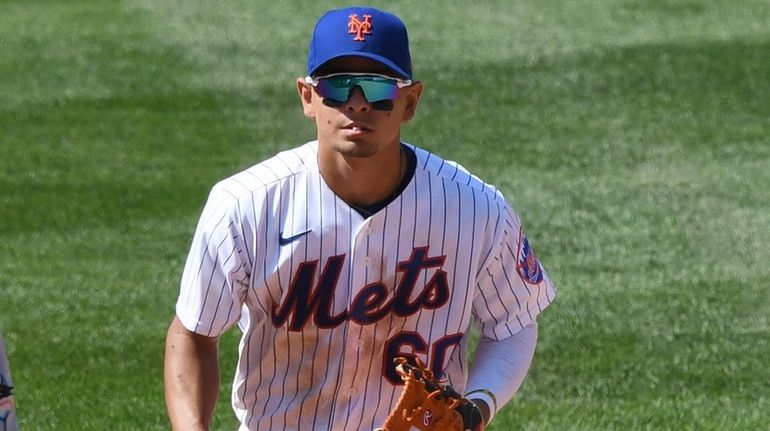 Mets second baseman Andres Gimenez runs to the dugout after...