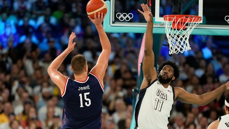 Nikola Jokic (15), of Serbia shoots over United States' Joel...