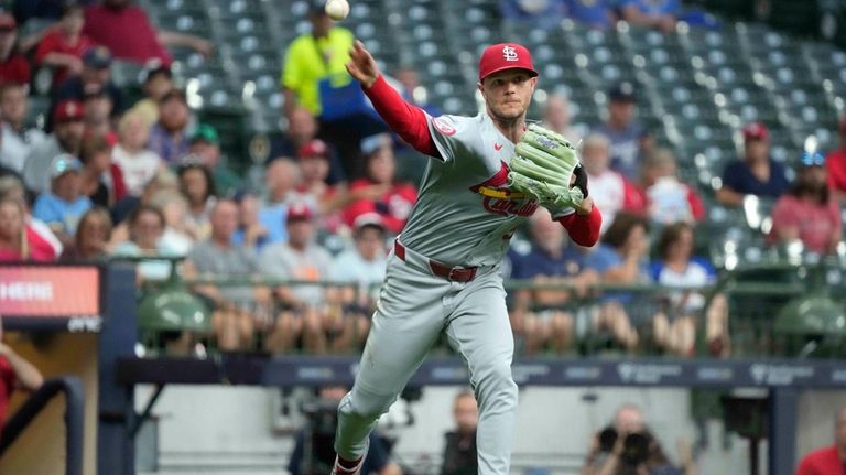 St. Louis Cardinals pitcher Sonny Gray throws to first for...