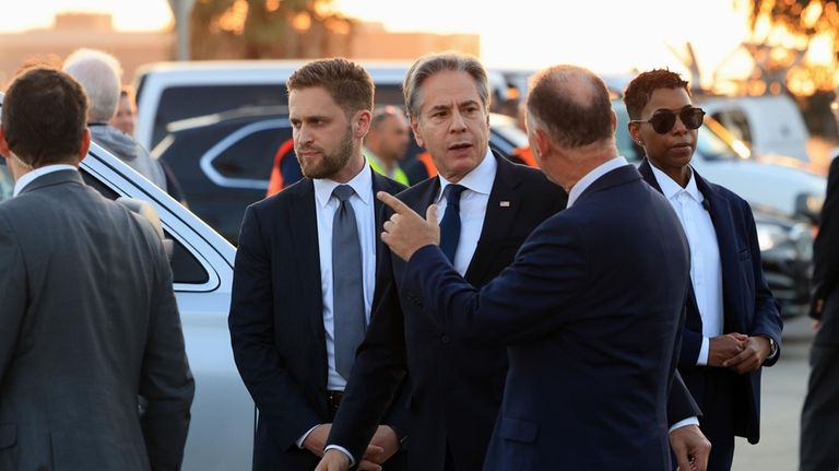 U.S. Secretary of State Antony Blinken looks on after his...