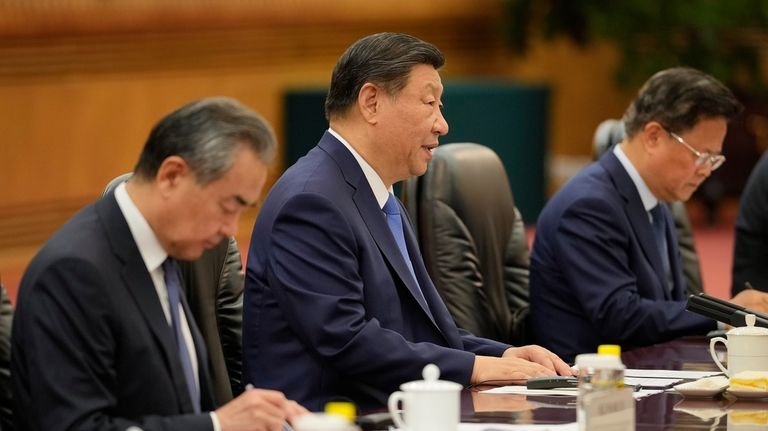 Chinese President Xi Jinping, second from left, with his delegation...