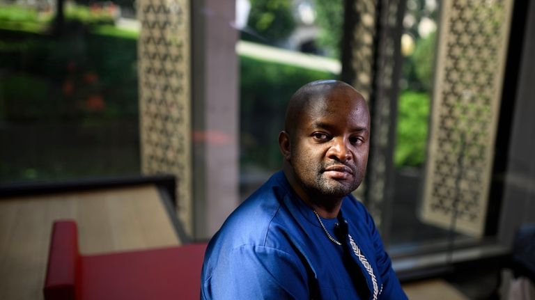 Pascal Kanyemera sits for a portrait at the National Arts...