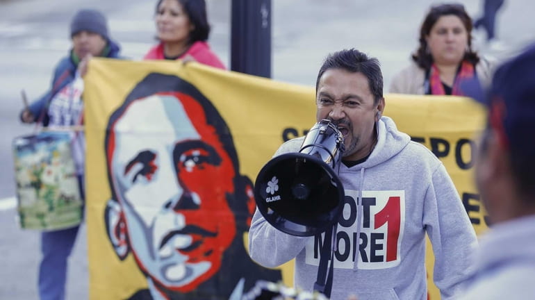 Tomas Martinez shouts into a megaphone during an immigration reform...