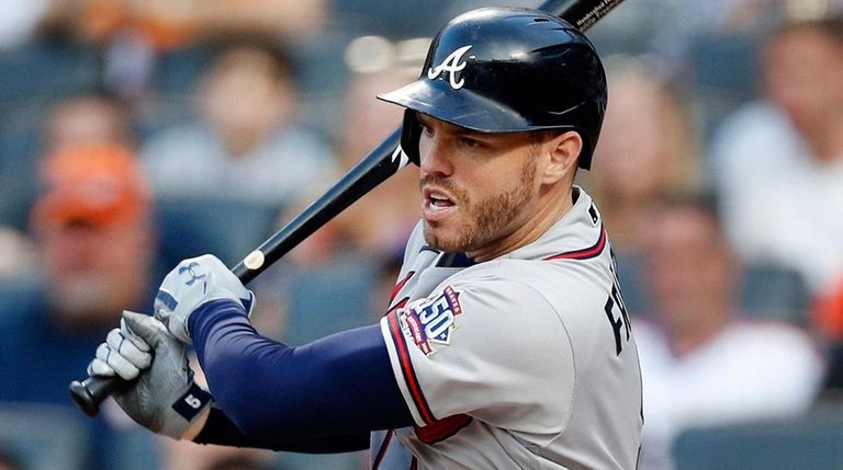 Freddie Freeman of Atlanta follows through on a base hit during...