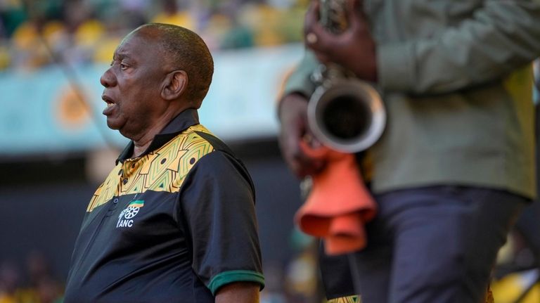 South African President Cyril Ramaphosa sings the national anthem at...