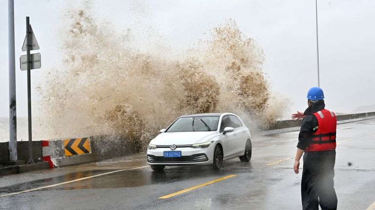 In this photo released by Xinhua News Agency, a car...