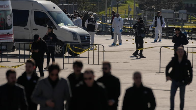 Security officers check the site where two attackers were killed...