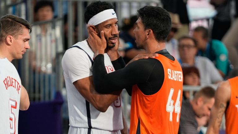 Arvin Slagter (44), of the Netherlands, consoles Kareem Maddox, of...