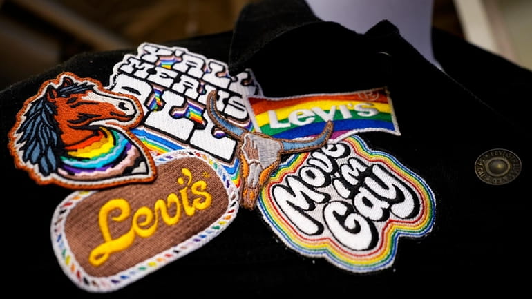A jacket with patches from Levi's Pride collection is displayed...