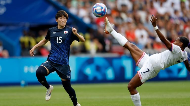 Japan's Aoba Fujino chases as Crystal Dunn of the United...