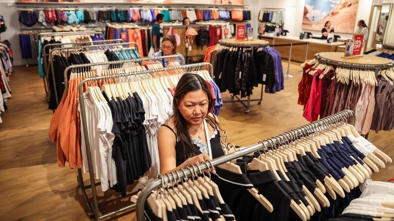 Jane Cohn of Merrick browses through clothing at Athleta at the Tanger...