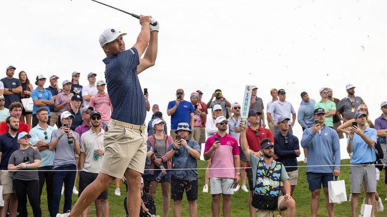 Captain Bryson DeChambeau, of Crushers GC, hits from the 15th...