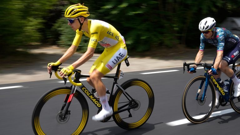 Slovenia's Tadej Pogacar, wearing the overall leader's yellow jersey, is...