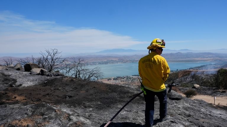 A Riverside County Fire Dept. firefighter monitors for hot spots...