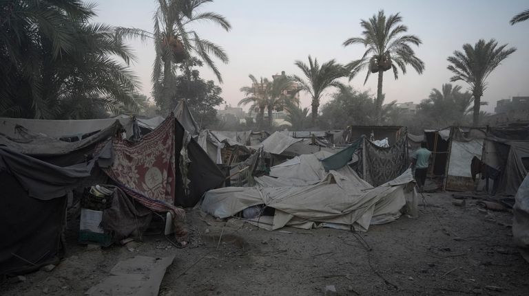 Tents are in disarray after an Israeli airstrike in Deir...