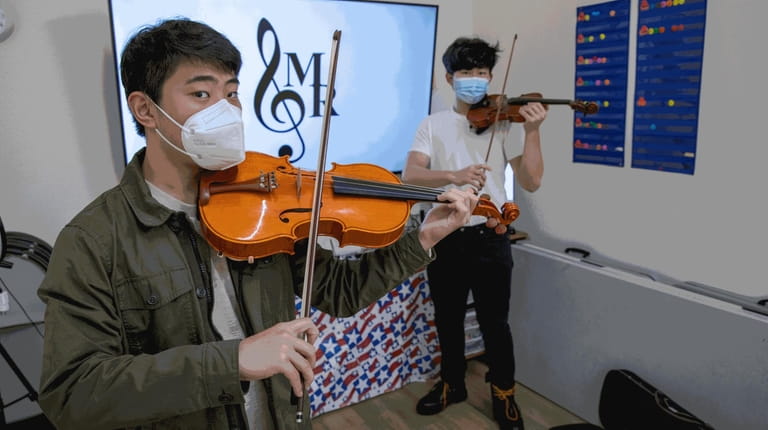 Musical Relief founders Michael Lan, 16, left, and Evan Cheng,...