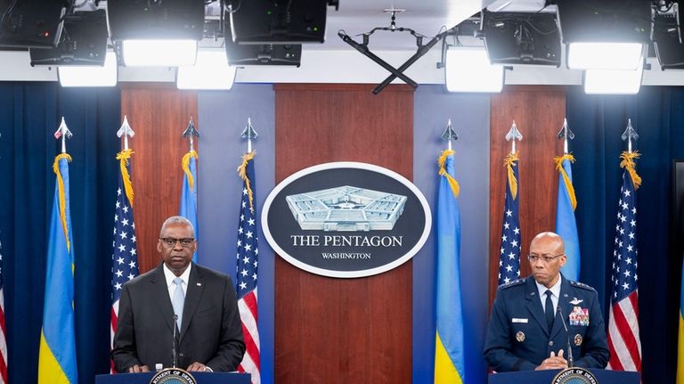 Defense Secretary Lloyd Austin, left, and Chairman of the Joint...