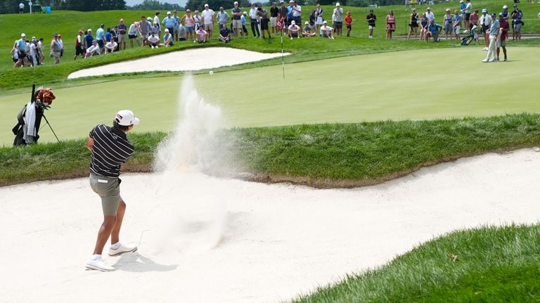 Charlie Woods hits onto the 17th green during the first...