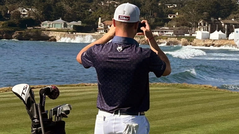 Justin Thomas stops to take a photo of the 18th...