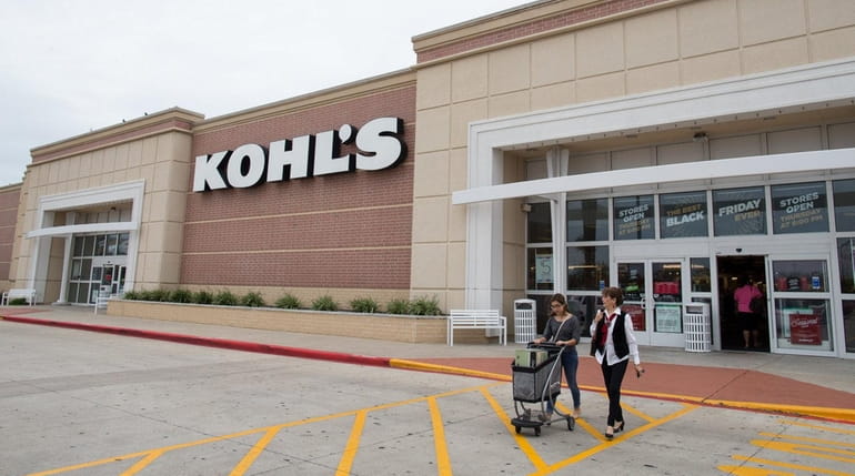 Shoppers push a cart of items as they leave Kohl's...