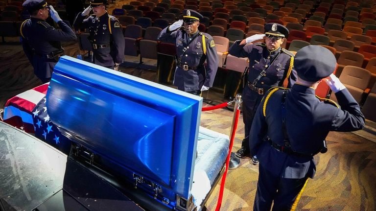 Members of the Dallas Police Honor Guard salute at the...