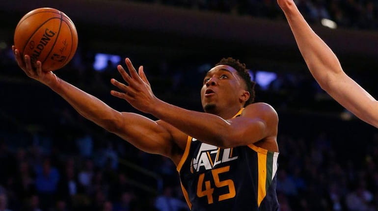 Donovan Mitchell #45 of the Utah Jazz goes to the...