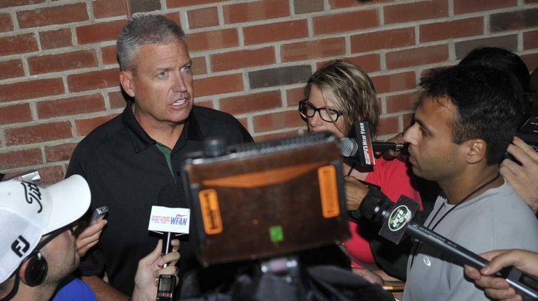 Jets head coach Rex Ryan talks with reporters at training...