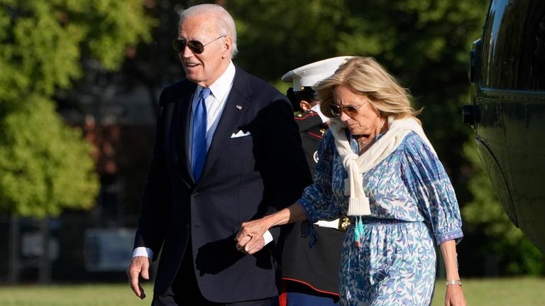 President Joe Biden, left, and first lady Jill Biden hold...