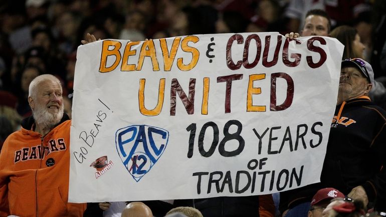 An Oregon State fans hold a "Pac-2" sign, representing the...