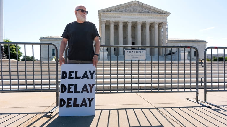 Activist Bill Christeson protests in front of the Supreme Court...