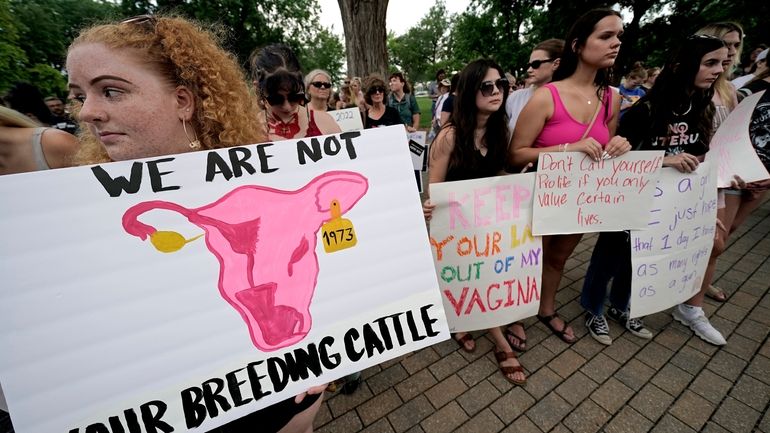 Abortion-rights advocates gather outside a the Kansas Statehouse in Topeka,...